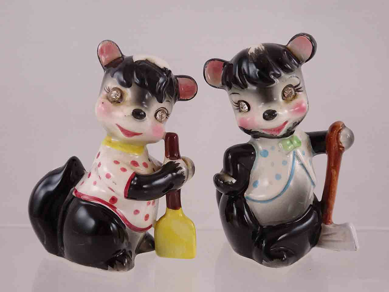 54173 Delicate Rhinestone Eyed Animals Holding Different Items - skunks with broom and axe salt and pepper shakers