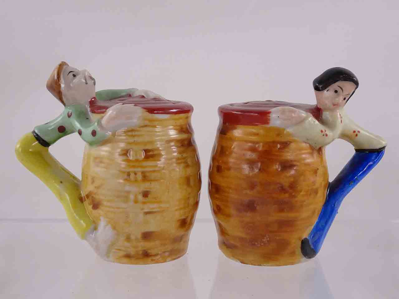 53980 People hanging off sides of baskets salt and pepper shakers