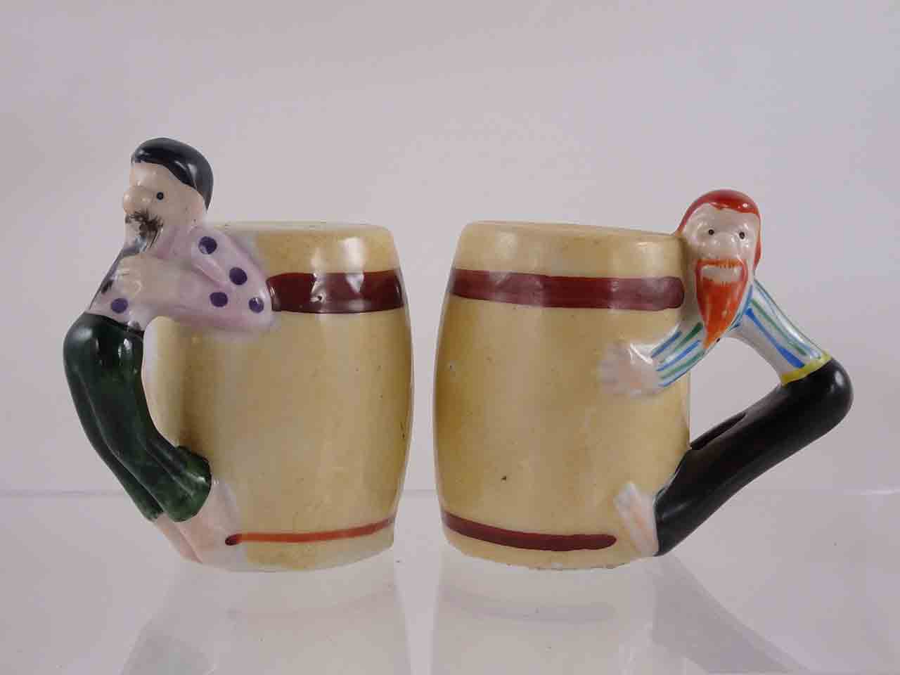 53983 People hanging off sides of barrels salt and pepper shakers